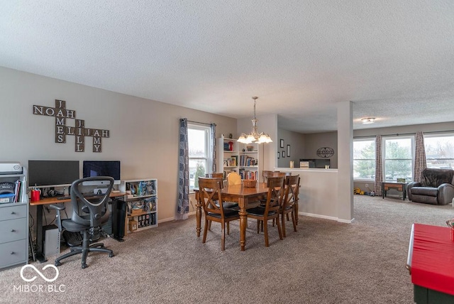 dining space with a textured ceiling, a wealth of natural light, carpet, and a notable chandelier