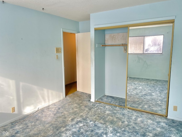 unfurnished bedroom with a closet, a textured ceiling, and carpet flooring