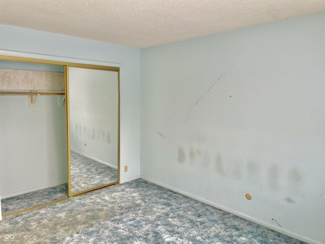 unfurnished bedroom with a closet and a textured ceiling