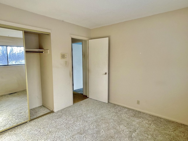 unfurnished bedroom with carpet floors and a closet