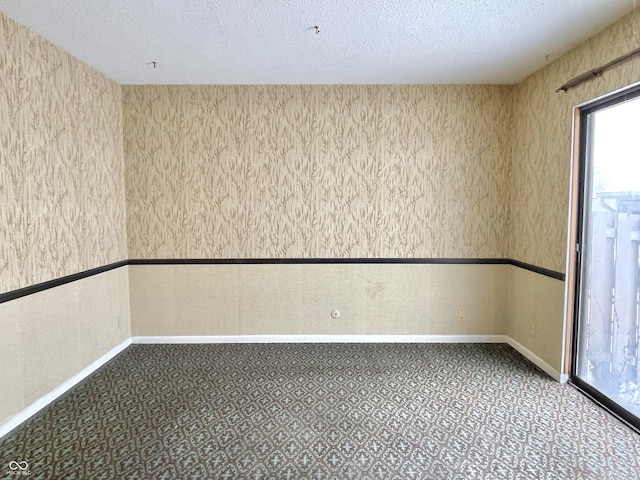 spare room with a textured ceiling