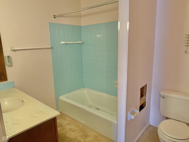 full bathroom featuring vanity, tiled shower / bath, and toilet