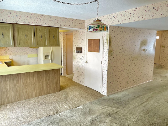 kitchen featuring a textured ceiling, kitchen peninsula, carpet floors, white fridge with ice dispenser, and pendant lighting