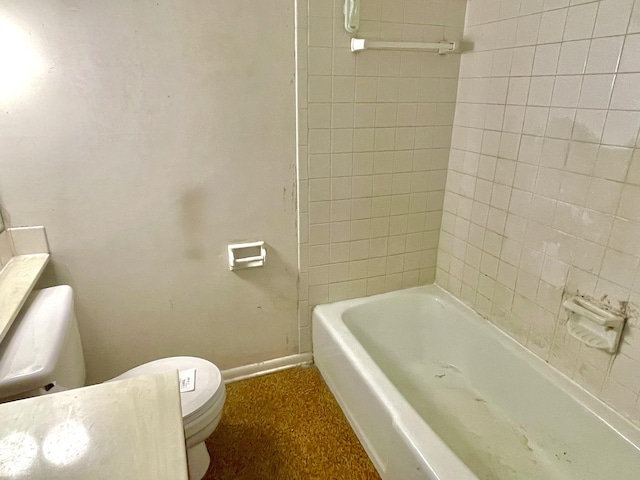 bathroom featuring toilet and a tub