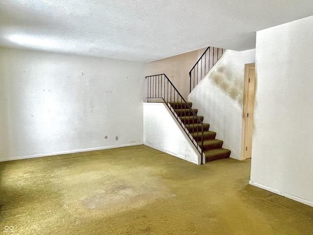 interior space with carpet floors and a textured ceiling