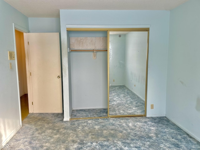 unfurnished bedroom with carpet and a closet