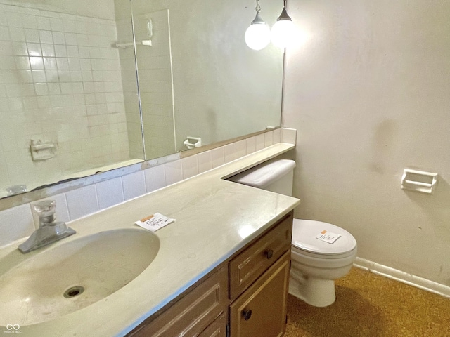 bathroom with vanity, decorative backsplash, and toilet