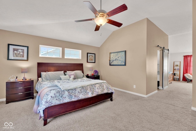 carpeted bedroom with ceiling fan, a barn door, and lofted ceiling