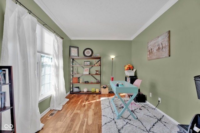 interior space with multiple windows, ornamental molding, and hardwood / wood-style floors