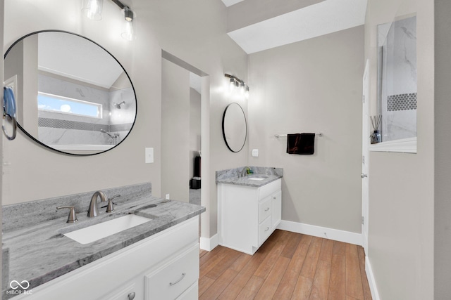 bathroom featuring a shower, wood-type flooring, and vanity