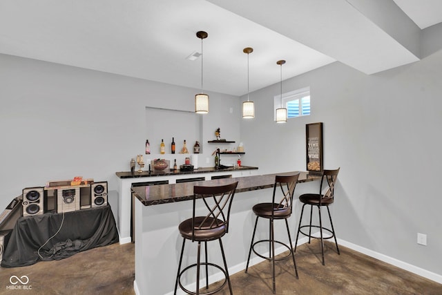 bar featuring white cabinetry and hanging light fixtures