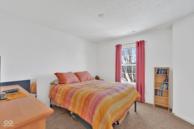 carpeted bedroom with a textured ceiling