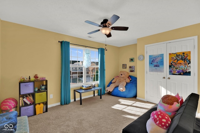 recreation room with light carpet and ceiling fan