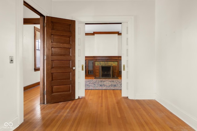 hall featuring ornamental molding and light wood-type flooring