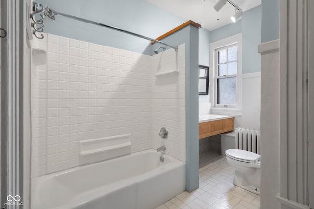 full bathroom with toilet, vanity, tub / shower combination, and radiator