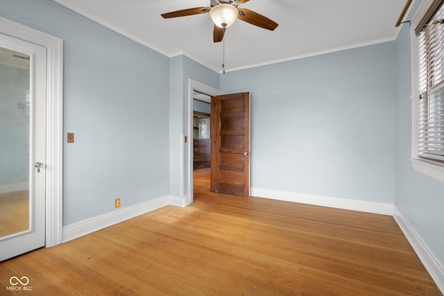 unfurnished bedroom with ceiling fan, wood-type flooring, and crown molding