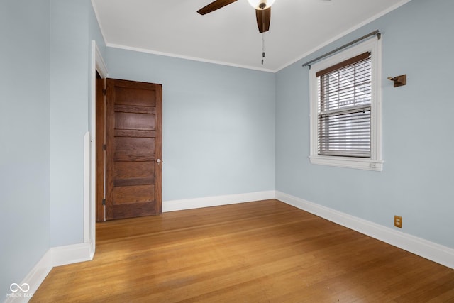 unfurnished room featuring light hardwood / wood-style floors, crown molding, and ceiling fan