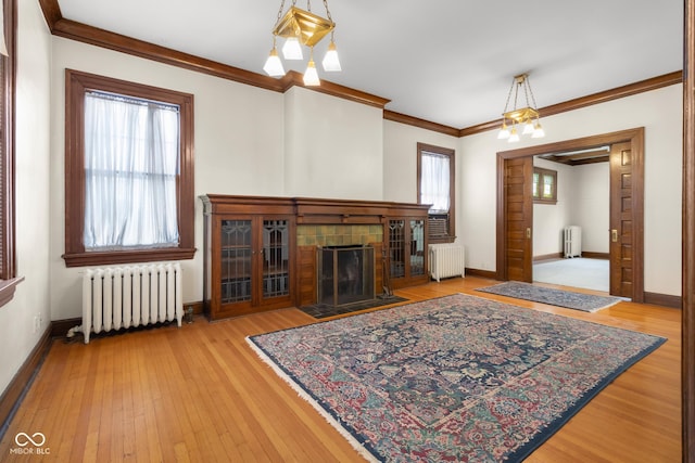 living room featuring radiator, plenty of natural light, and a chandelier