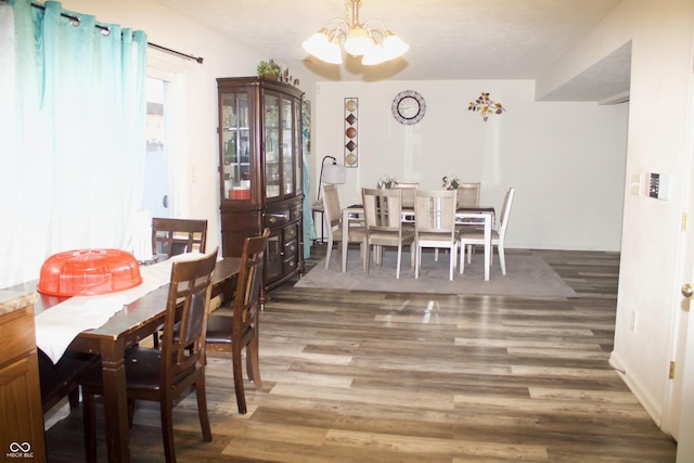 dining room with an inviting chandelier and hardwood / wood-style floors