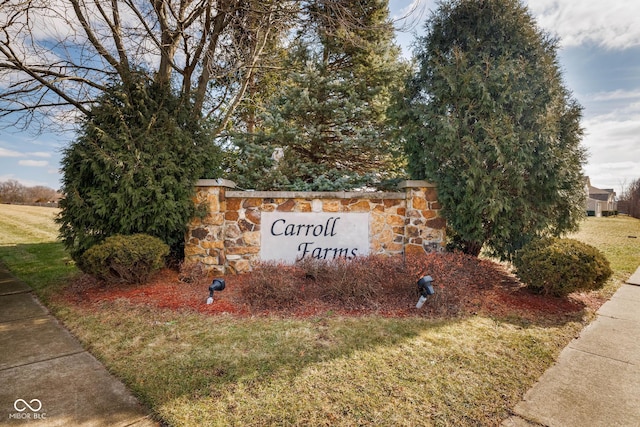 community / neighborhood sign with a lawn