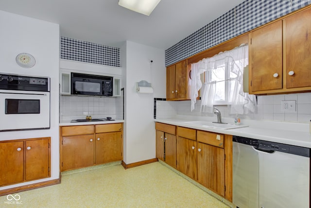 kitchen featuring sink, white oven, gas cooktop, dishwasher, and decorative backsplash