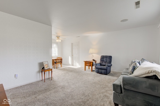 carpeted living room featuring ceiling fan