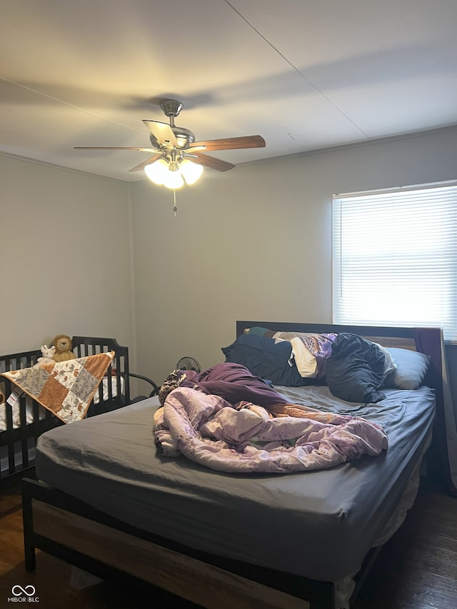 bedroom featuring ceiling fan and dark hardwood / wood-style flooring