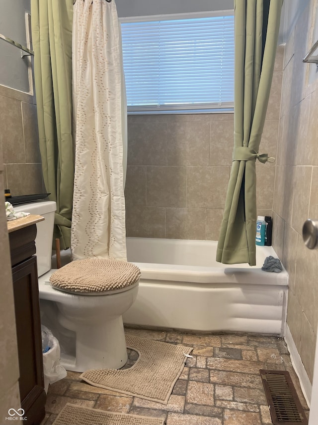 full bathroom featuring toilet, vanity, and shower / bath combo