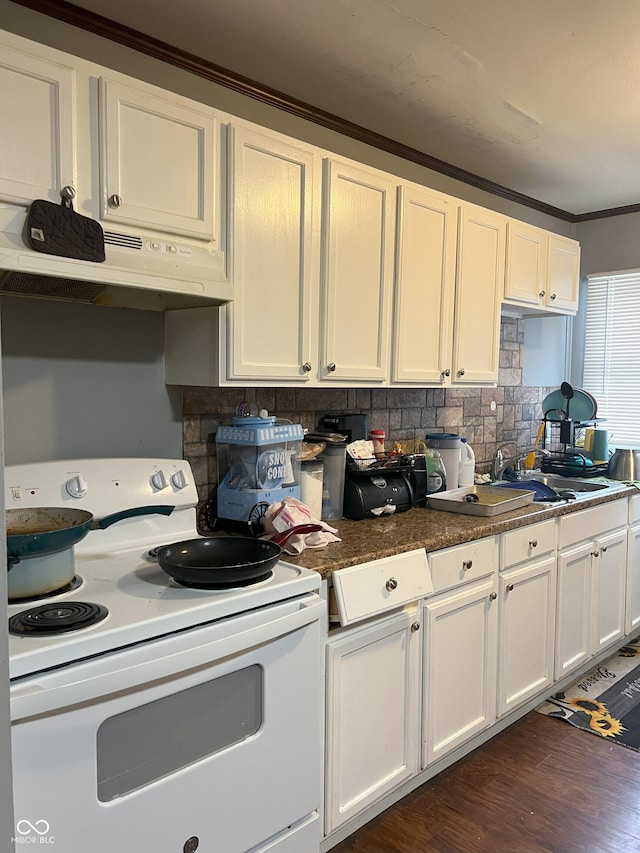 kitchen with white cabinetry, dark hardwood / wood-style flooring, white range with electric cooktop, backsplash, and ornamental molding