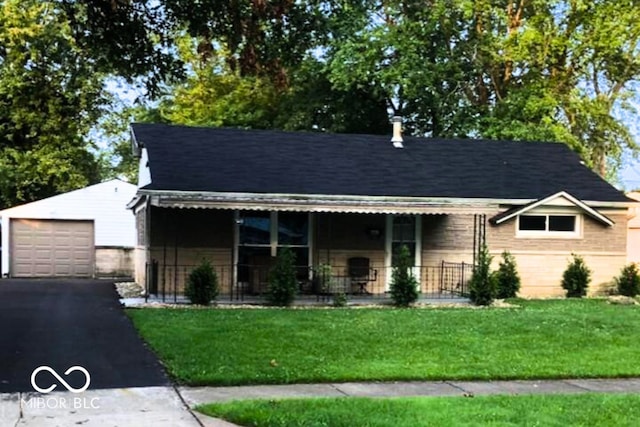 view of front of house featuring a garage, an outdoor structure, a front lawn, and a porch