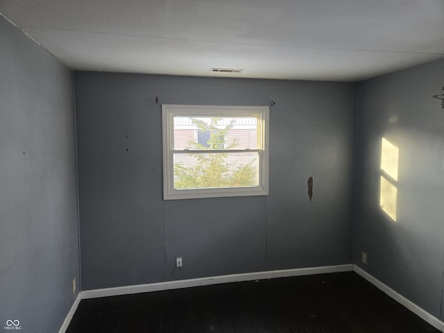 empty room with hardwood / wood-style floors