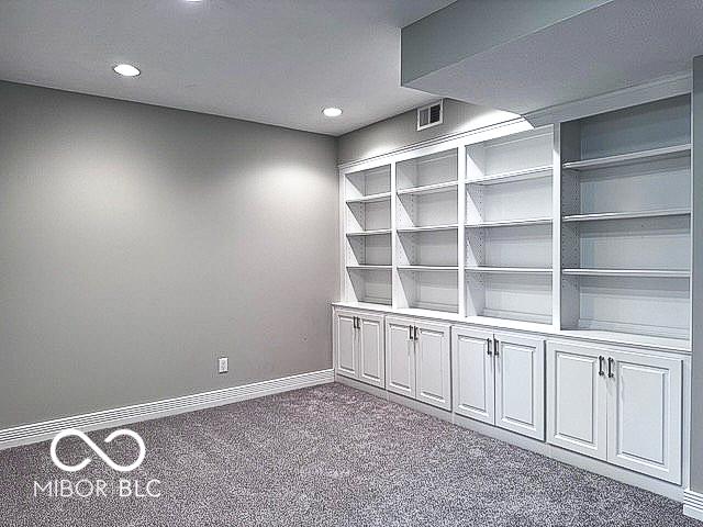 13650 Golden Ridge Ln, Fishers, IN 46055 - empty room featuring dark carpet and recessed lighting