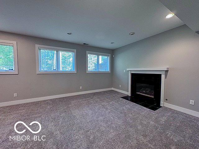 13650 Golden Ridge Ln, Fishers, IN 46055 - unfurnished living room with carpet flooring, a fireplace with flush hearth, and recessed lighting