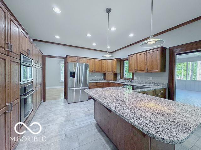13650 Golden Ridge Ln, Fishers, IN 46055 - kitchen with stainless steel appliances, crown molding, plenty of natural light, light stone counters, and recessed lighting