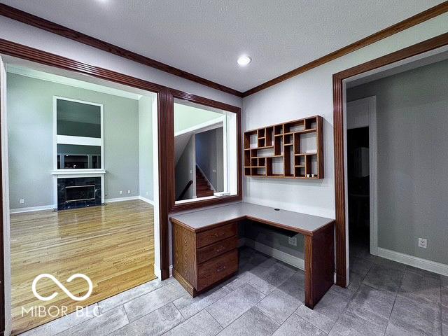 13650 Golden Ridge Ln, Fishers, IN 46055 - unfurnished office featuring ornamental molding, built in study area, recessed lighting, a textured ceiling, and a fireplace