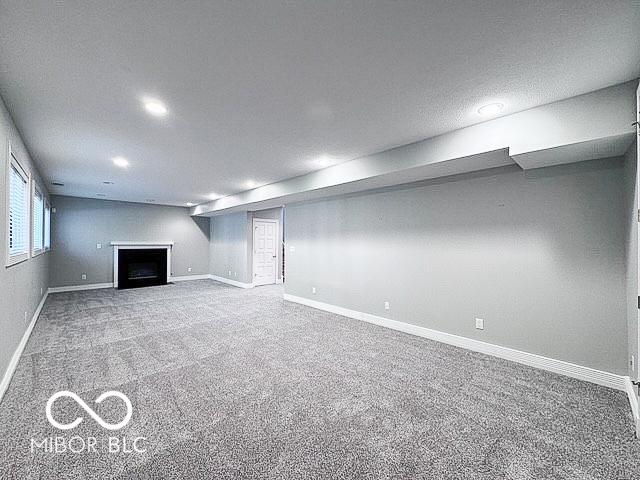 13650 Golden Ridge Ln, Fishers, IN 46055 - below grade area featuring carpet, a fireplace, and recessed lighting