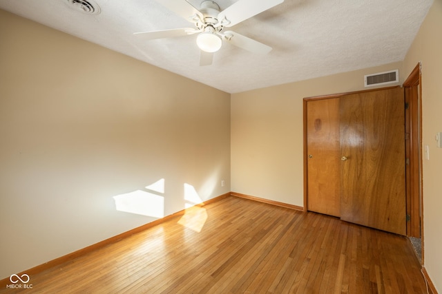 unfurnished bedroom with a closet, ceiling fan, and hardwood / wood-style floors