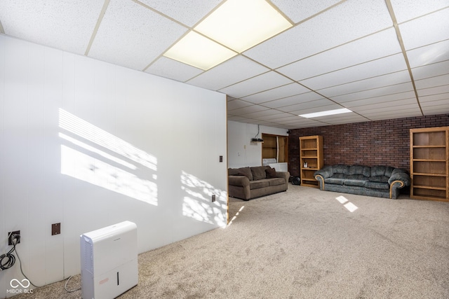 unfurnished living room featuring a paneled ceiling and carpet