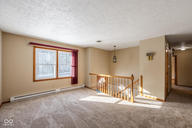 unfurnished room featuring a textured ceiling, a baseboard heating unit, and carpet flooring