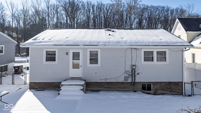 view of snow covered rear of property