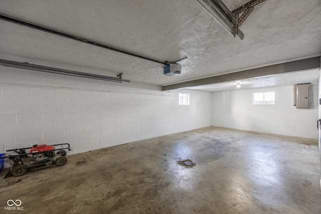 garage with electric panel and a garage door opener