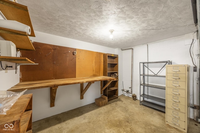 basement with a workshop area and a textured ceiling