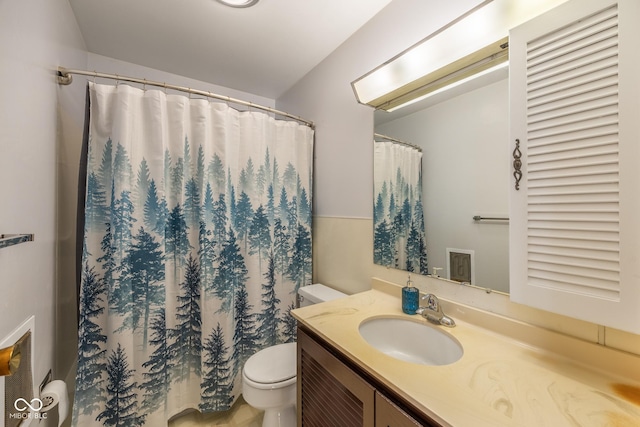 bathroom with vanity, toilet, and walk in shower