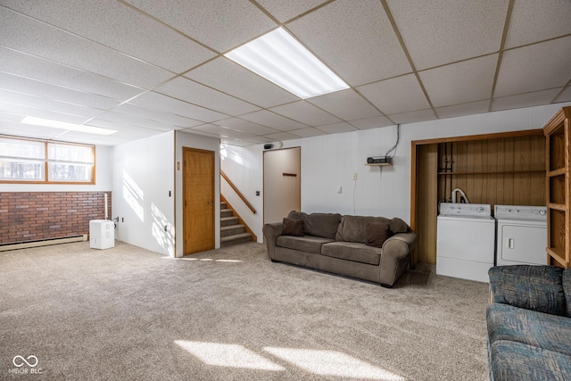 carpeted living room featuring washer and dryer, a baseboard heating unit, and a paneled ceiling