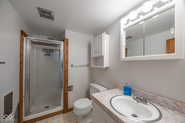 bathroom with toilet, a shower with shower door, and vanity