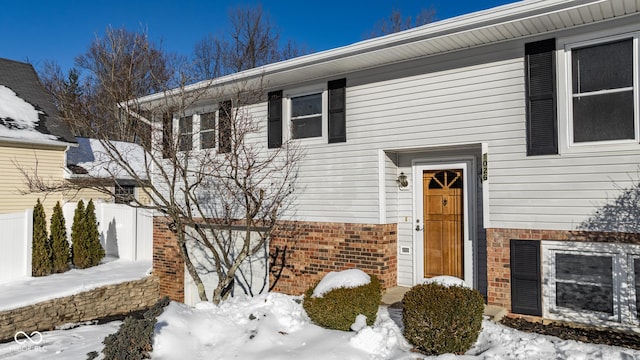 view of snow covered property entrance