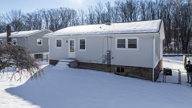 view of snow covered rear of property