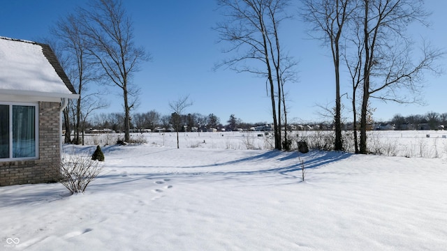 view of yard layered in snow