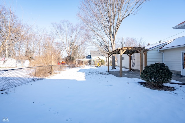 yard covered in snow featuring a pergola