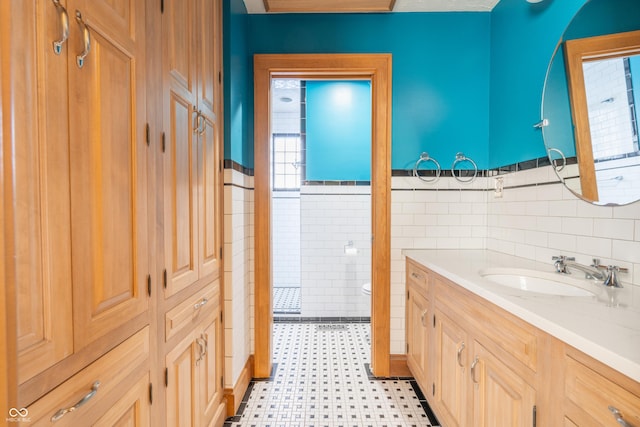 bathroom featuring tile walls, toilet, and vanity